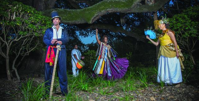 Four costumed people stand beneath an Ansemen Oak tree.