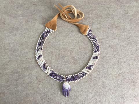 A stone and leather collar, or necklace.