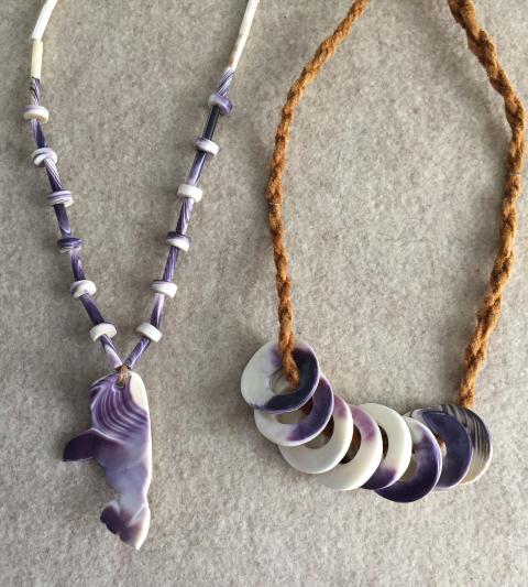 Necklaces made with purple and white wampum and leather.