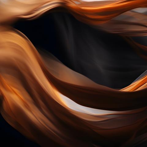 Flowing orange and blue chiffon over a black backdrop.