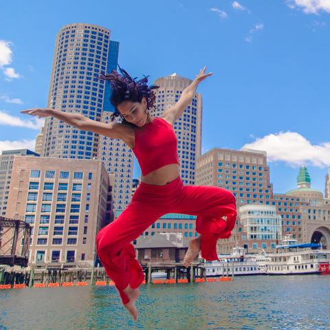 Marsha Parilla leaps by the waterfront