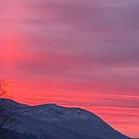 A pink sunset over mountains.
